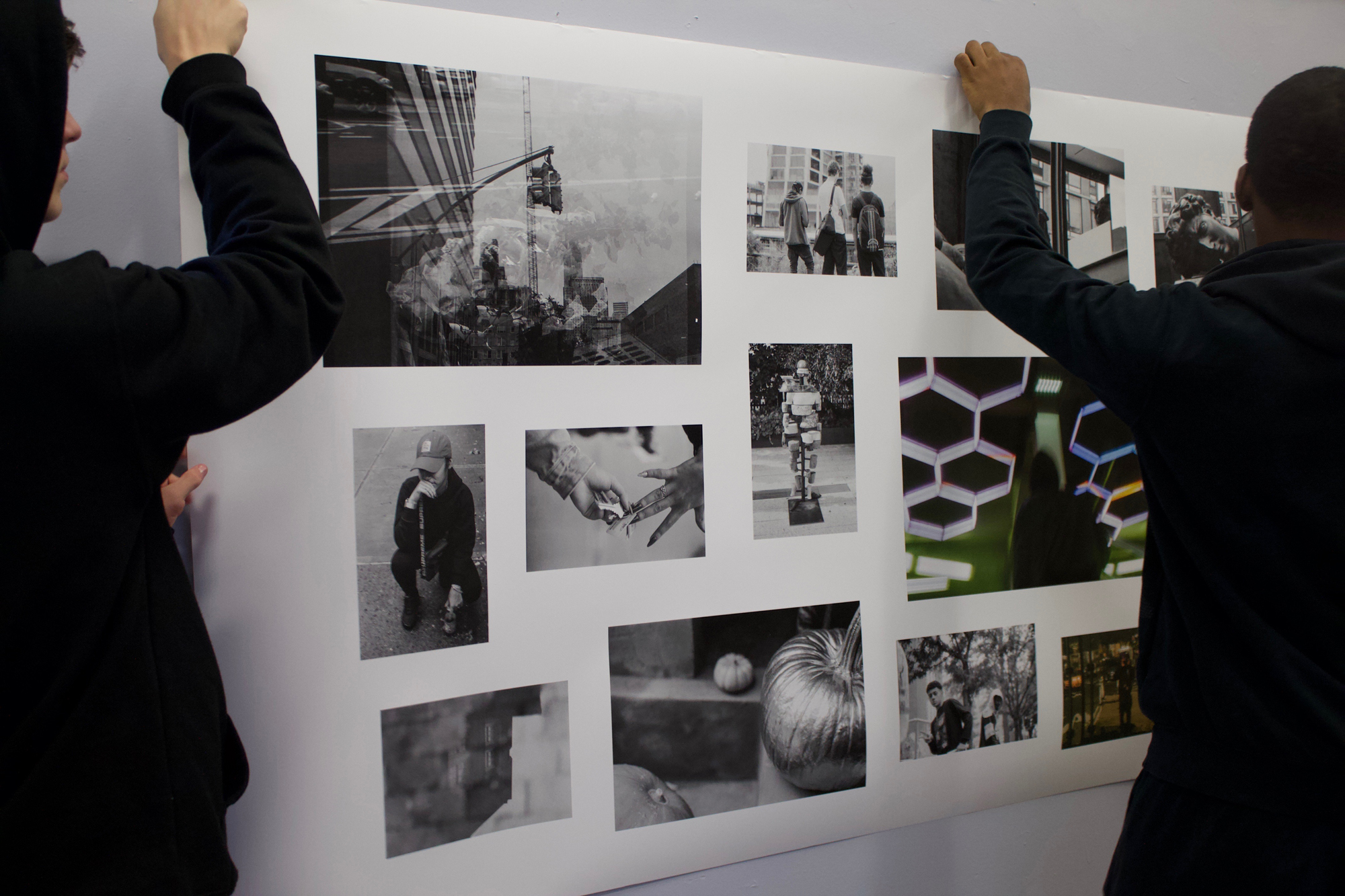 Two students holding up a grid of photos on a white background.