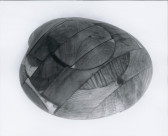 A black and white photograph of a wooden clam sculpture.