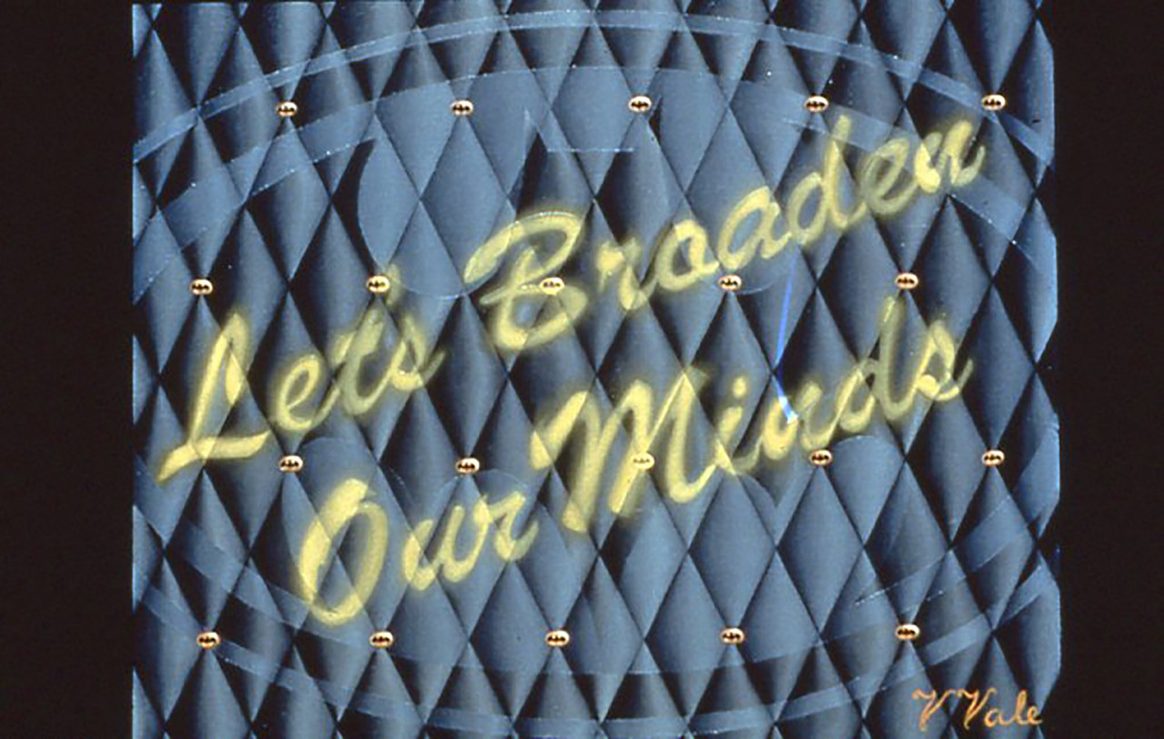 Yellow cursive text superimposed over an array of plush, blue diamonds. The text is slightly hazy and reads, 