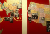 Two maps, one of Asia and one of the Western United States, on red backgrounds positioned side by side. Black and white photographs are overlaid on particular cities in each map.