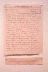 A pink piece of paper with the typed text 