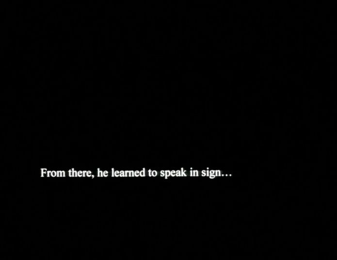 White text on a black screen reads: “From there, he learned to speak in sign…”
