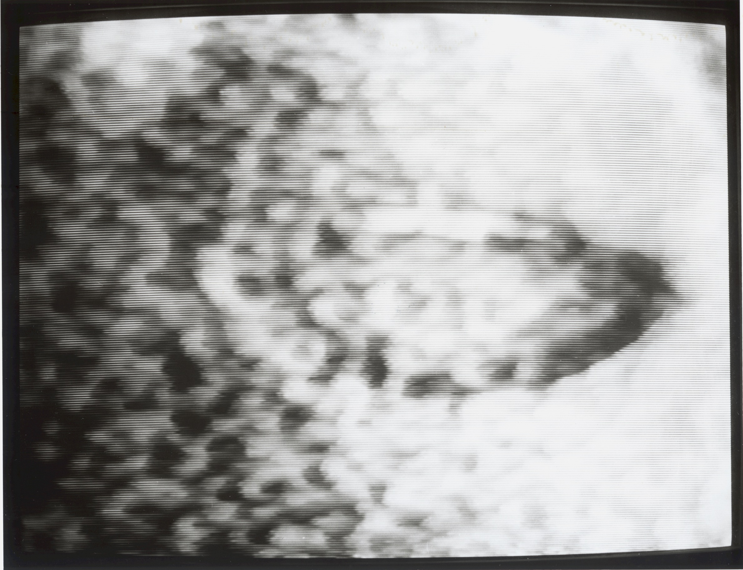 A mouth silently forms the shape of the eight Korean vowel graphemes while video noise or ‘snow’ threatens to drown it out.