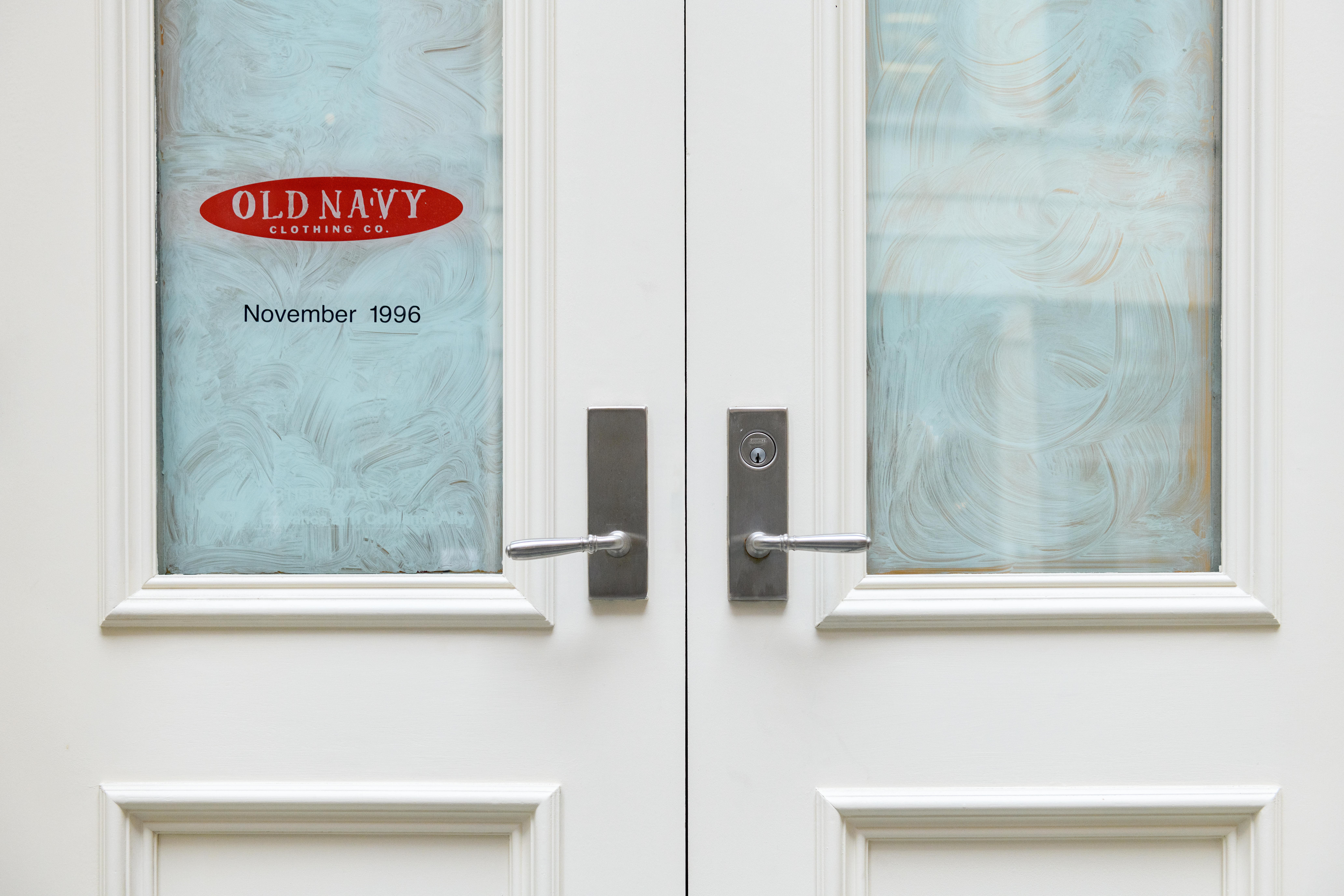 A close up of glazed over windows displaying the Old Navy logo and the date 