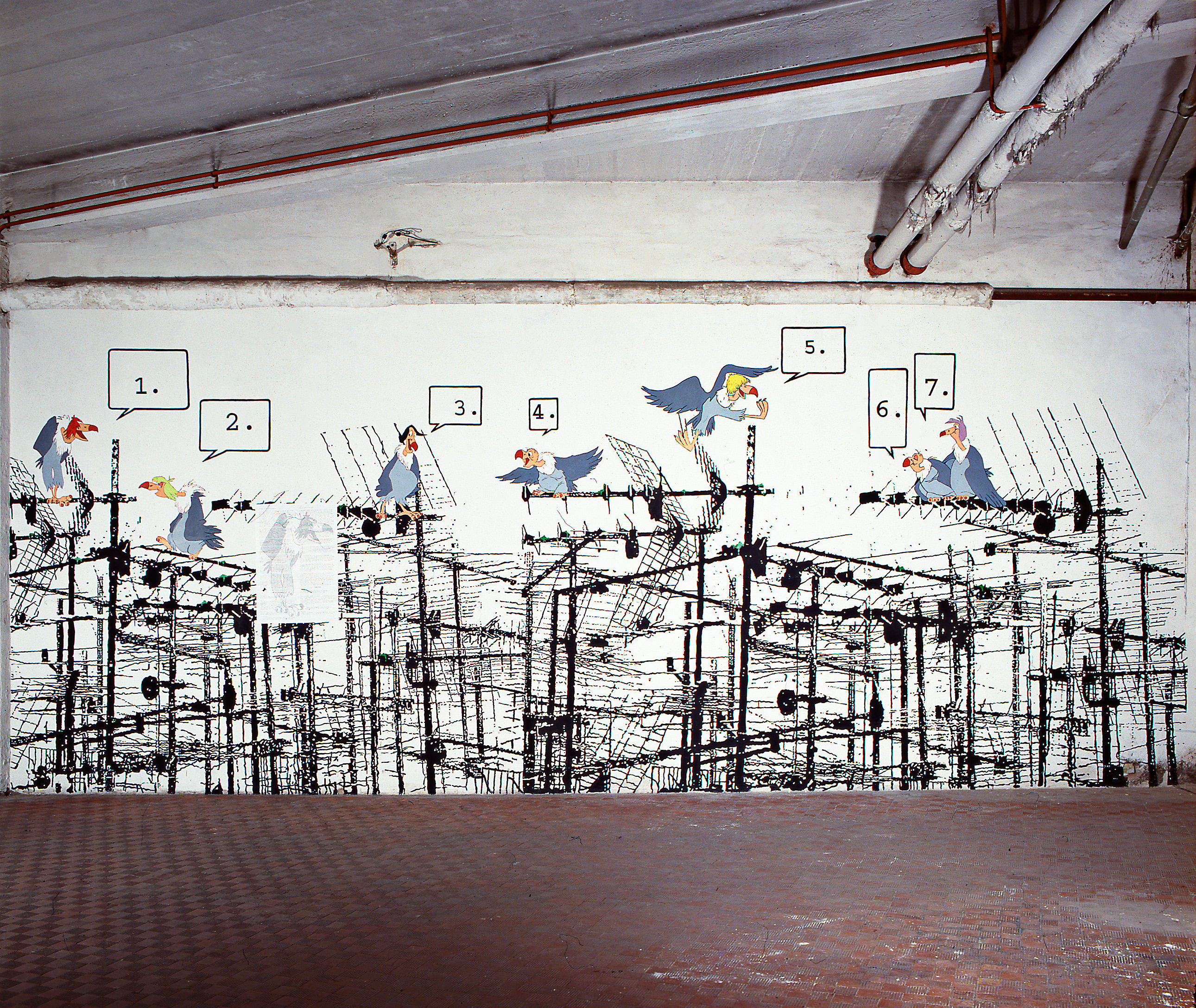 A painting on the wall of an industrial room depicts a network of television antennas, repeated horizontally. Cartoon birds sit atop the poles, each with a numbered speech bubble floating above their heads.