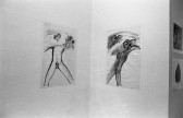 Two drawings hung up on adjacent walls. On the left is a nude headless figure with a star covering its groin and smaller figures walking along the top. On the right is a nude headless figure with two disembodied heads floating nearby with long extended tongues.