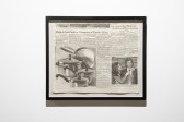 Color image of a framed fragment of newspaper. The headlines of the two articles featured read, 