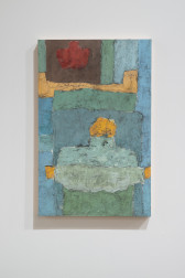 Color image of an abstract oil and wax work on panel, featuring various layers of light blue, green, yellow, and red swatches of paint, done in geometric shapes.