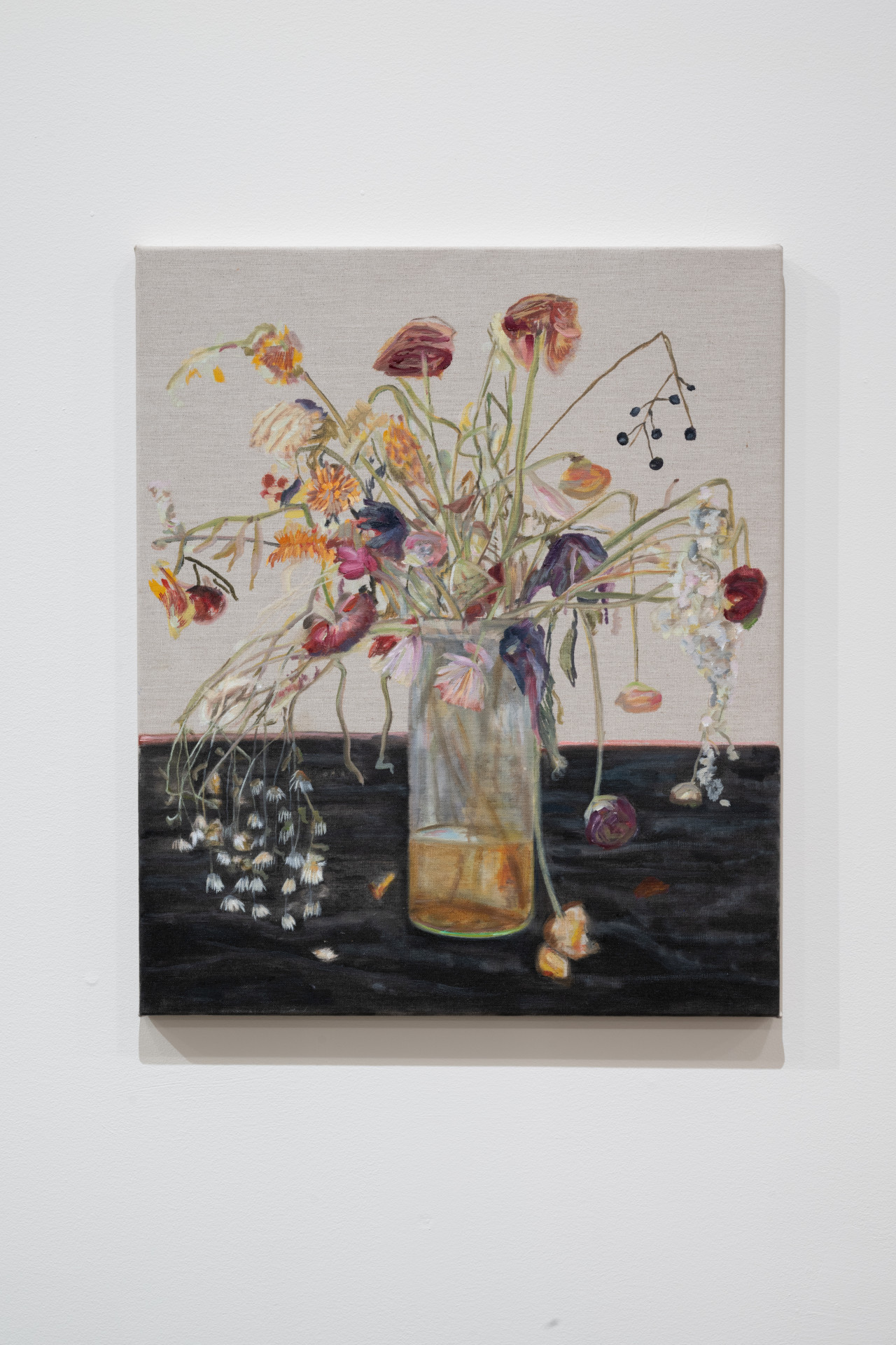 Color image of an oil painting of a flower arrangment, placed in a glass jar on a black table. The flowers are dying and falling over the sides of the jar, which holds a shallow amount of yellowed water.