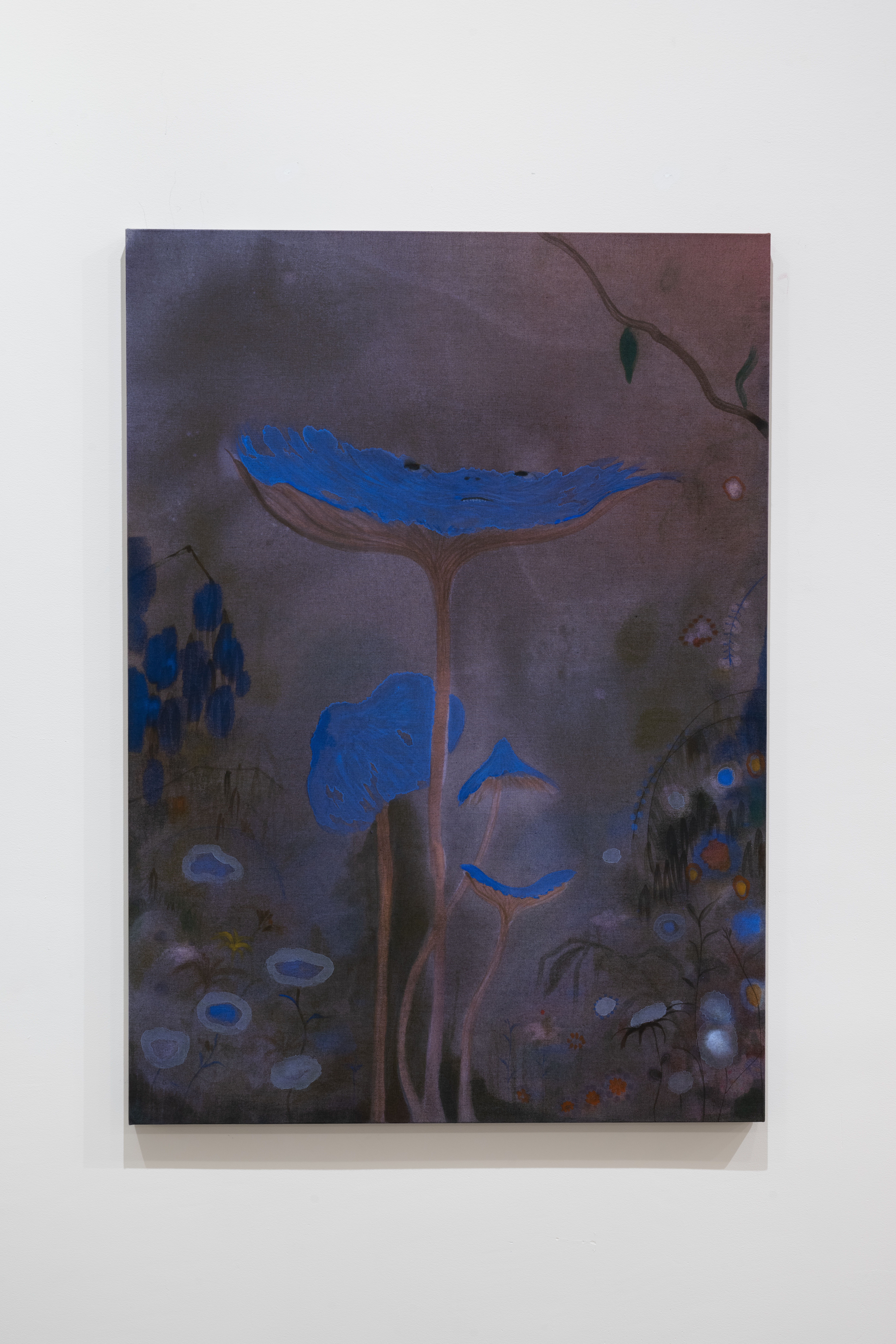 Color image of a watercolor painting. Against a purple and brown background, emerge flowers with bright blue petals opening up in the middle of the composition. In the background, other blue flowers, and plants surround them. A pair of eyes, nose and mouth are painted over the largest blue flower placed in the middle.