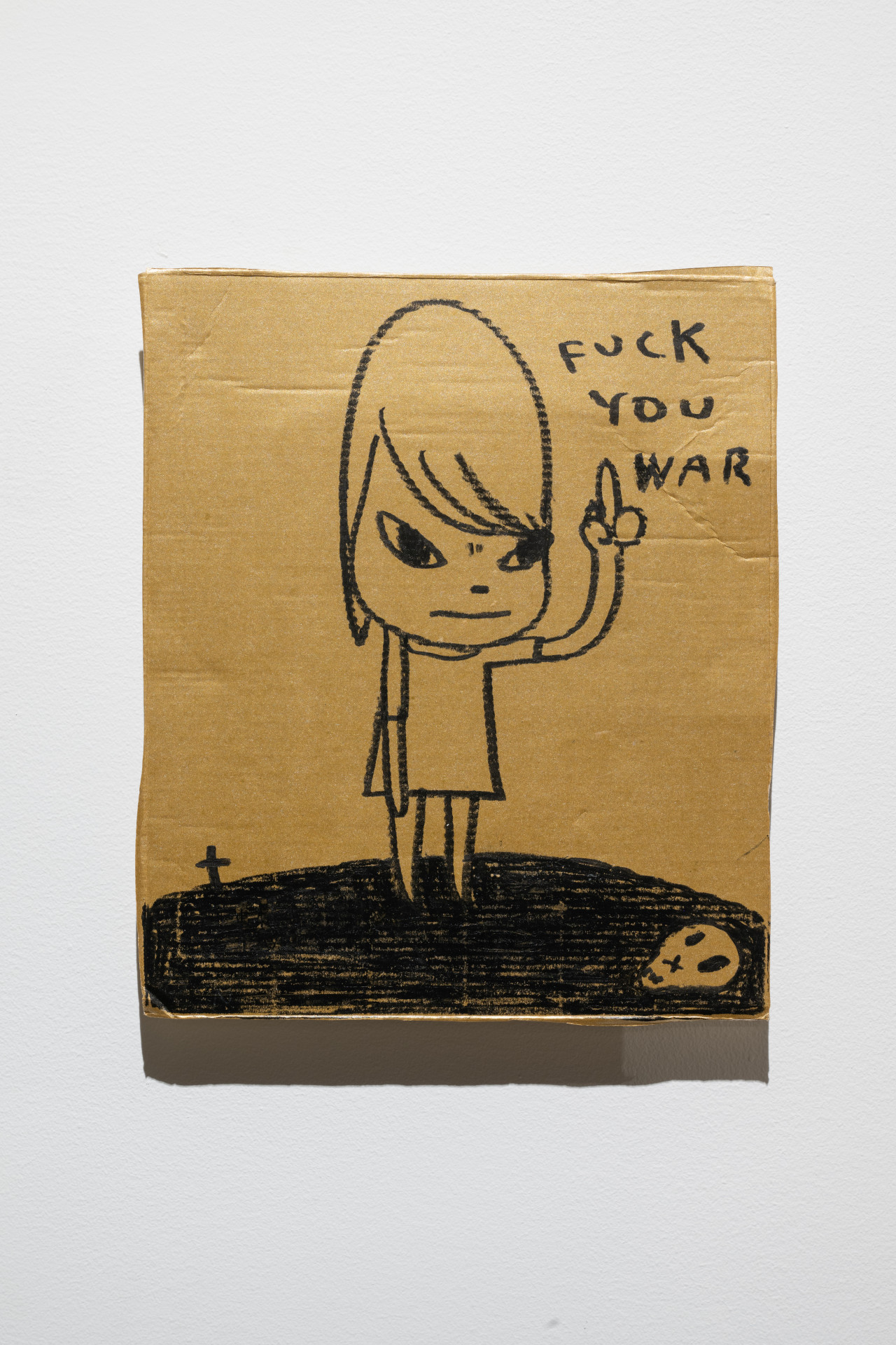 Color image of a drawing of a cartoon girl, standing on a black hill, against a gold background. The girl holds up her middle finger, and above it in the top-right corner is text that reads "FUCK YOU WAR."