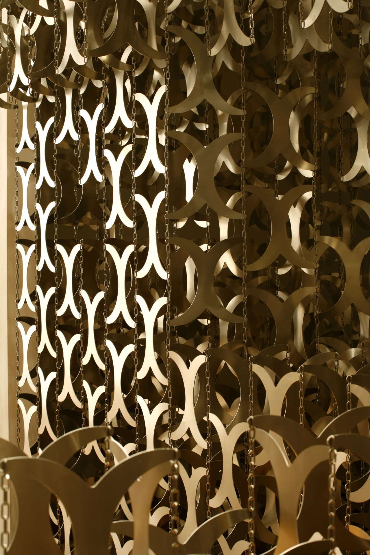 Close-up of a series of metal cutouts shaped like curved "x"