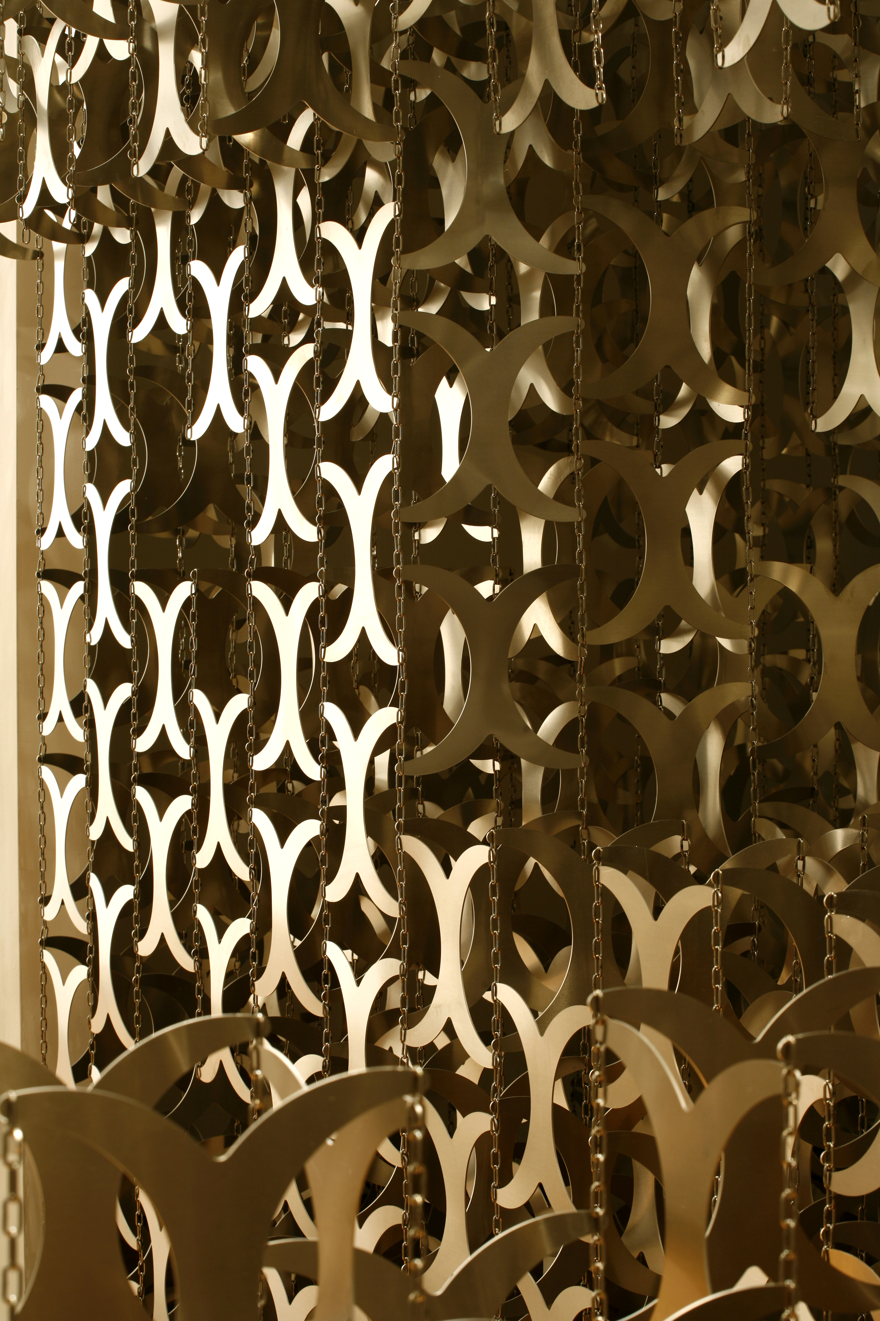Close-up of a series of metal cutouts shaped like curved 