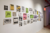 An image of a brightly lit wall, upon which various ephemera are mounted.