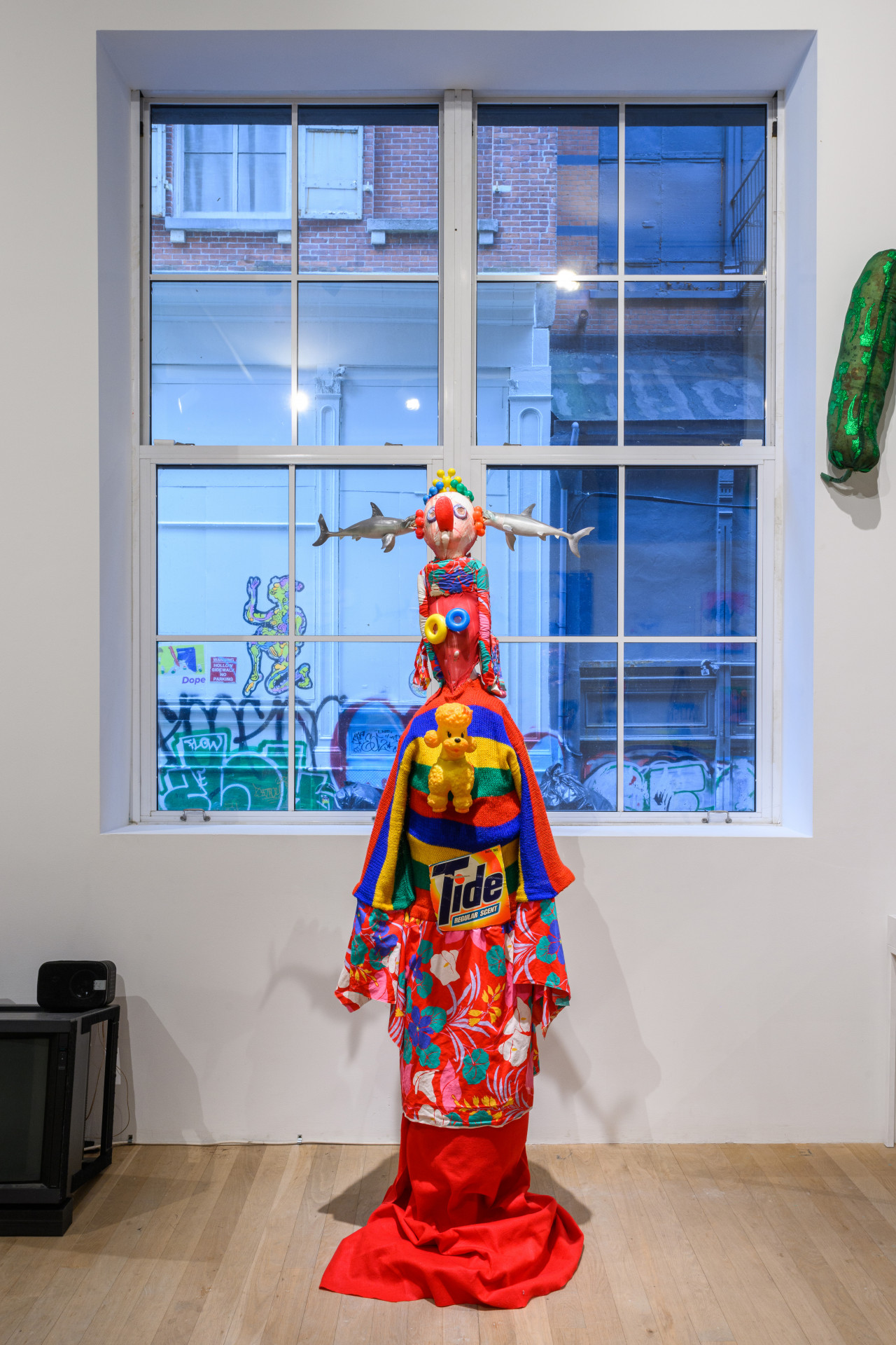 A life-sized costume in front of a large glass window.