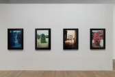 Four photographs, each with a monochromatic haze and black borders, hang in a line. 
