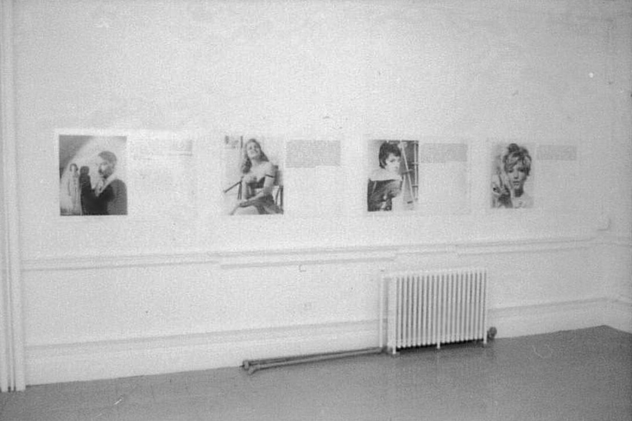 Photographs hanging on a wall in a gallery space.