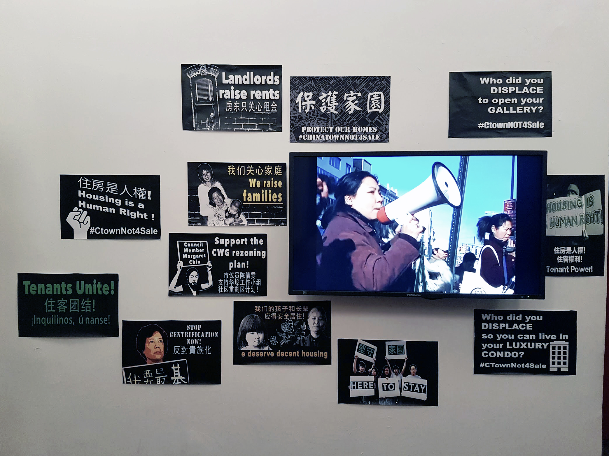 Chinatown anti-gentrification paraphrenelia posted on the wall, with phrases like 
