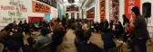 View of the audience at the Artists Space and Decolonize This Place event, with banners of resistance posted along the walls. One visible reads 