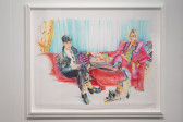 A colorful drawing depicts an image with blue and yellow background, and two elegant figures sitting on a red couch. They are both looking towards the viewer. On the right, a female-presenting figure wearing a pink suit has her legs up on the couch. The male-presenting figure is on the left. He is cross-legged and wearing a black suit. At their feet, a cat stretches.