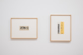 Two works on paper hanging on a white gallery wall. The work on the left features curling black lines that accrete densely in various clusters. The work on the right features two overlapping pieces of paper with a box in the top-left corner that reads 