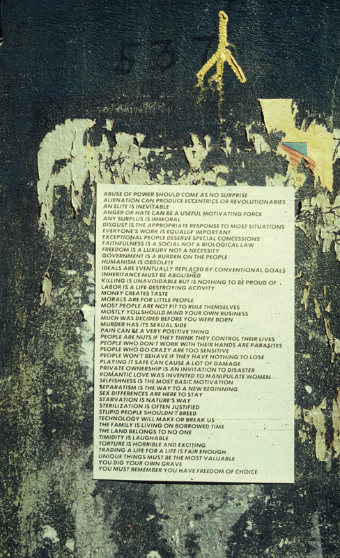 Gritty street wall background with a white poster on it with black text that reads, "ABUSE OF POWER SHOULD COME AS NO SURPRISE / ALIENATION CAN PRODUCE ECCENTRICS OR REVOLUTIONARIES / AN ELITE IS INEVITABLE / ANGER OR HATE CAN BE A USEFUL MOTIVATING FORCE / ANY SURPLUS IS IMMORAL / DISGUST IS THE APPROPRIATE RESPONSE TO MOST SITUATIONS / EVERYONE