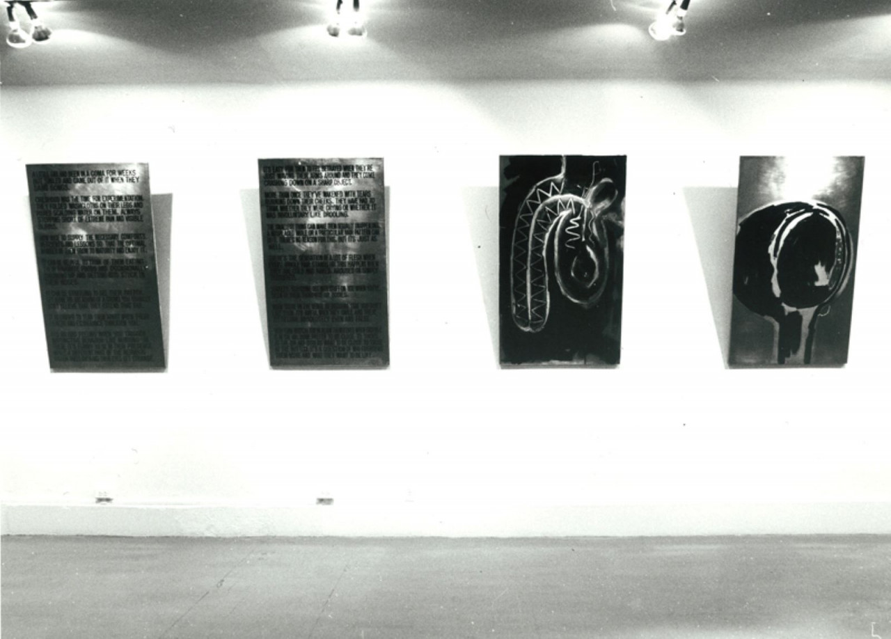 Four lined up rectangular panels jutting out from the gallery walls.