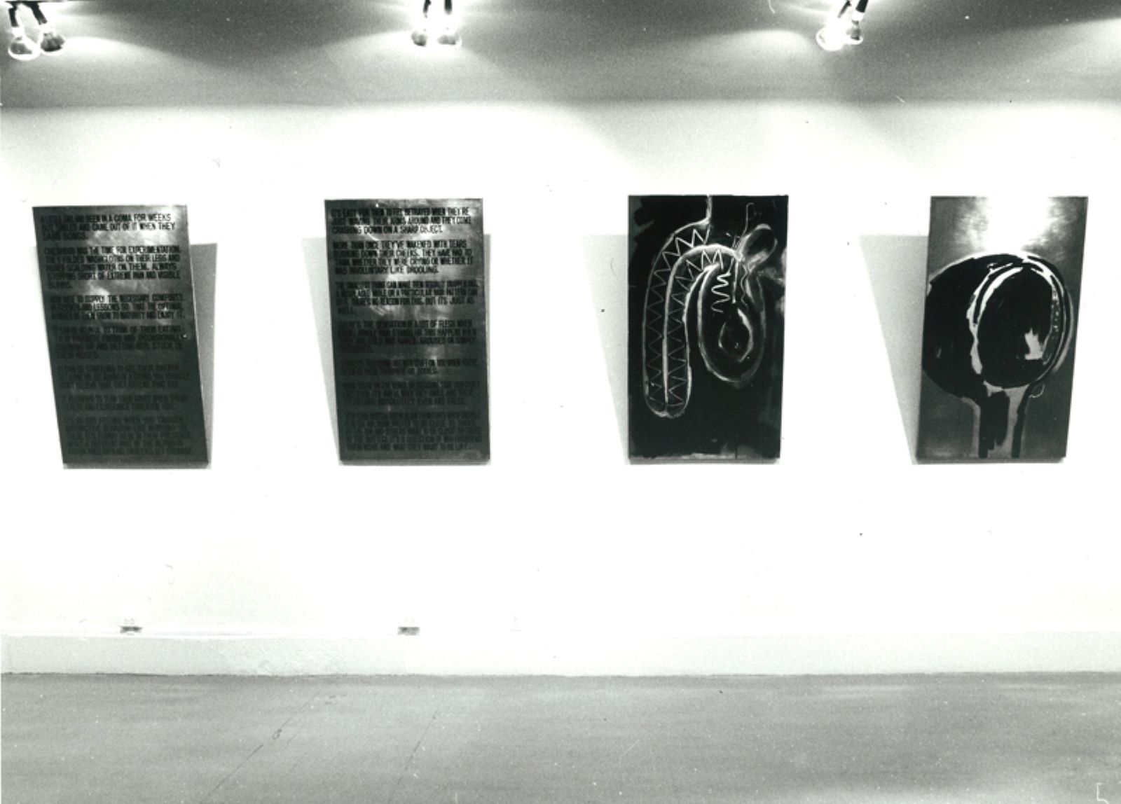 Four lined up rectangular panels jutting out from the gallery walls.