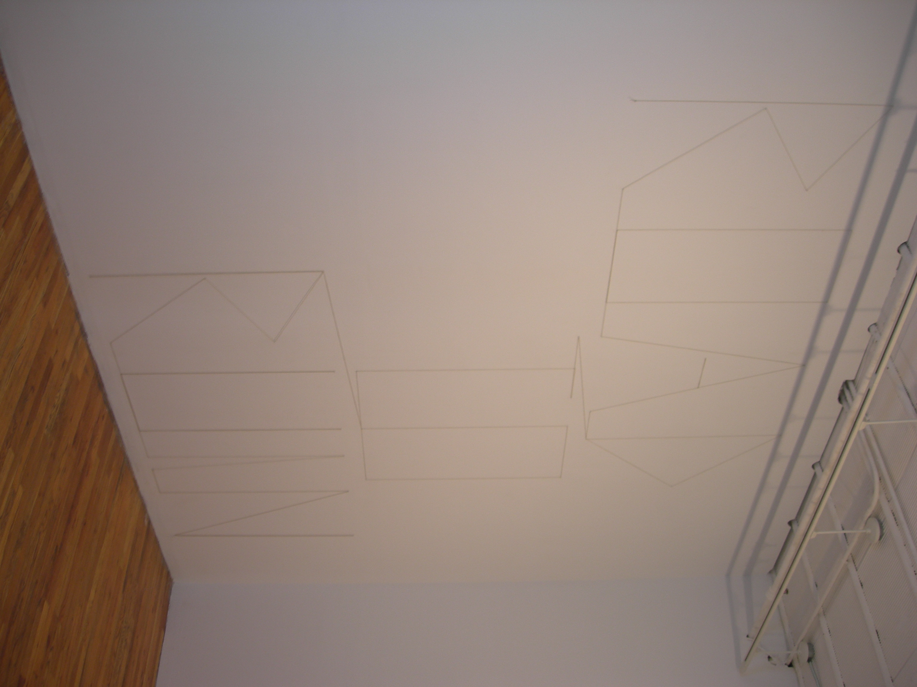 A white ceiling with penciled text reading 