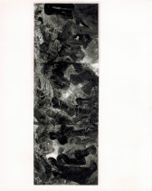 A black and white photograph of a tall, narrow rectangle-shaped painting of abstract swirls hanging on a white wall.