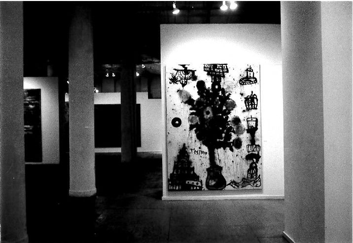 A large painting appears in a white-gallery space with various drawings of city architecture around a large amorphous black section in the middle. White columns and other paintings are visible in the surrounding area.