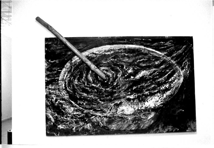 A large stick appears emerging from an image of reverberating water out of the image onto the upper lefthand corner of the gallery wall.