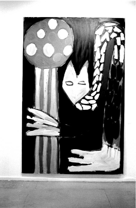 A figurative painting shows a cat-like figure drooping down to grab a long mushroom-like object. Painting appears in a white-walled gallery space.