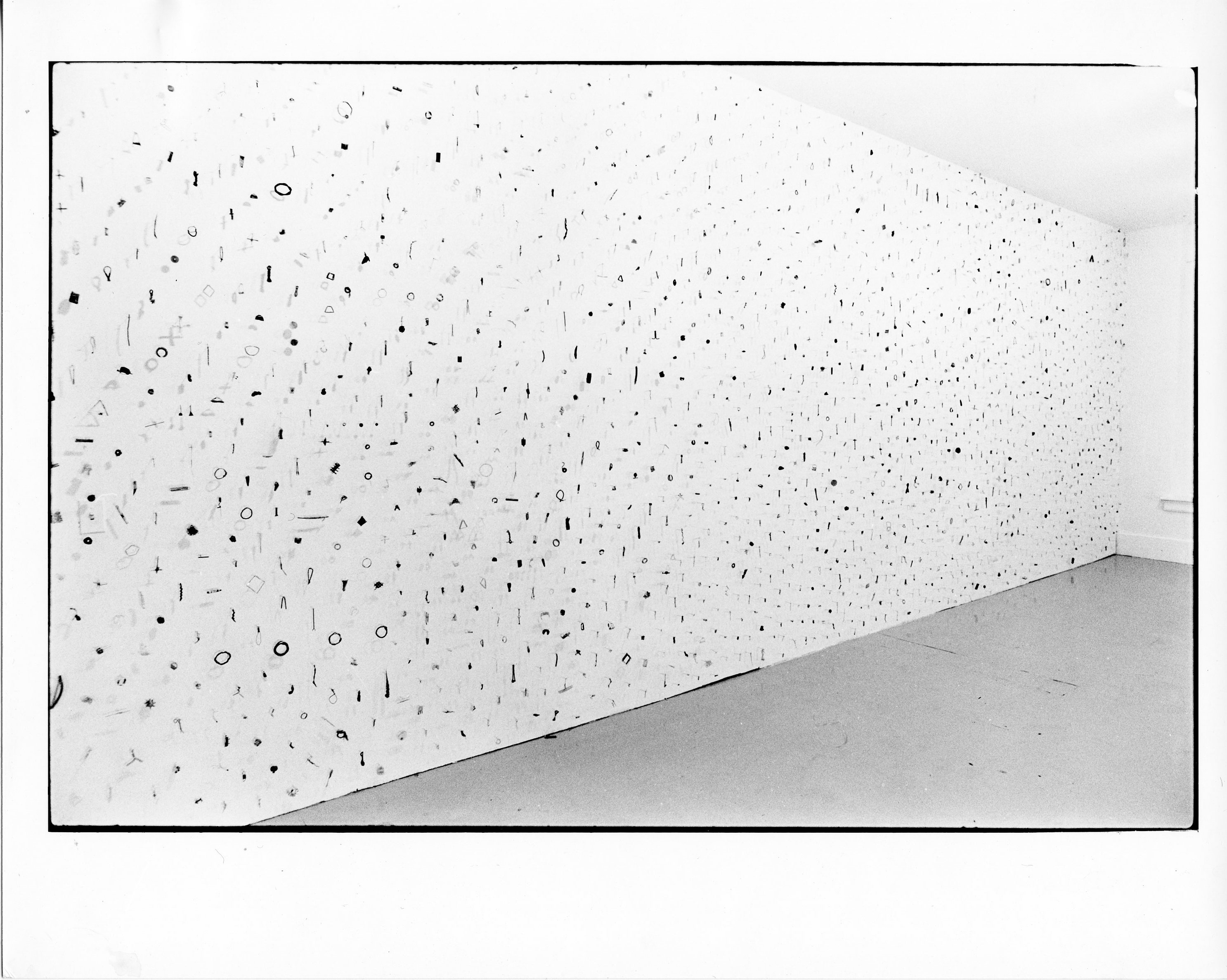 A photograph of small metal circles and bars on a white background.