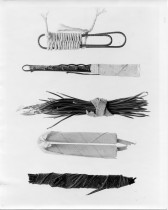 A photograph of a paper clip wrapped in twine, bobby pins wrapped in linen, and wrapped wires, lined up in a row.