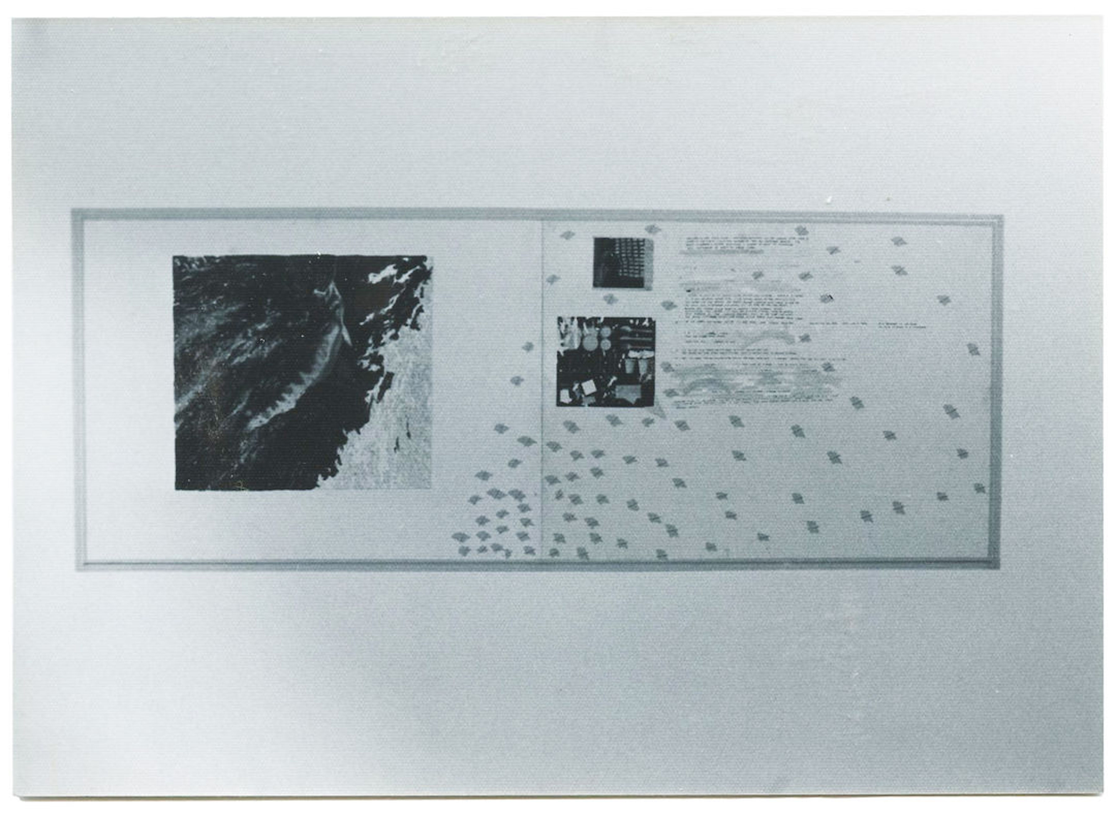 A black and white installation view of a large rectangular artwork featuring several dark portions, dots, and text.