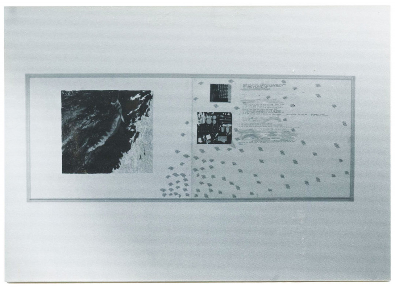 A black and white installation view of a large rectangular artwork featuring several dark portions, dots, and text.