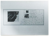 A black and white installation view of a large rectangular artwork featuring several dark portions, dots, and text.