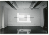 An image is projected onto a white wall. The image consists of various simple rectangular shapes.