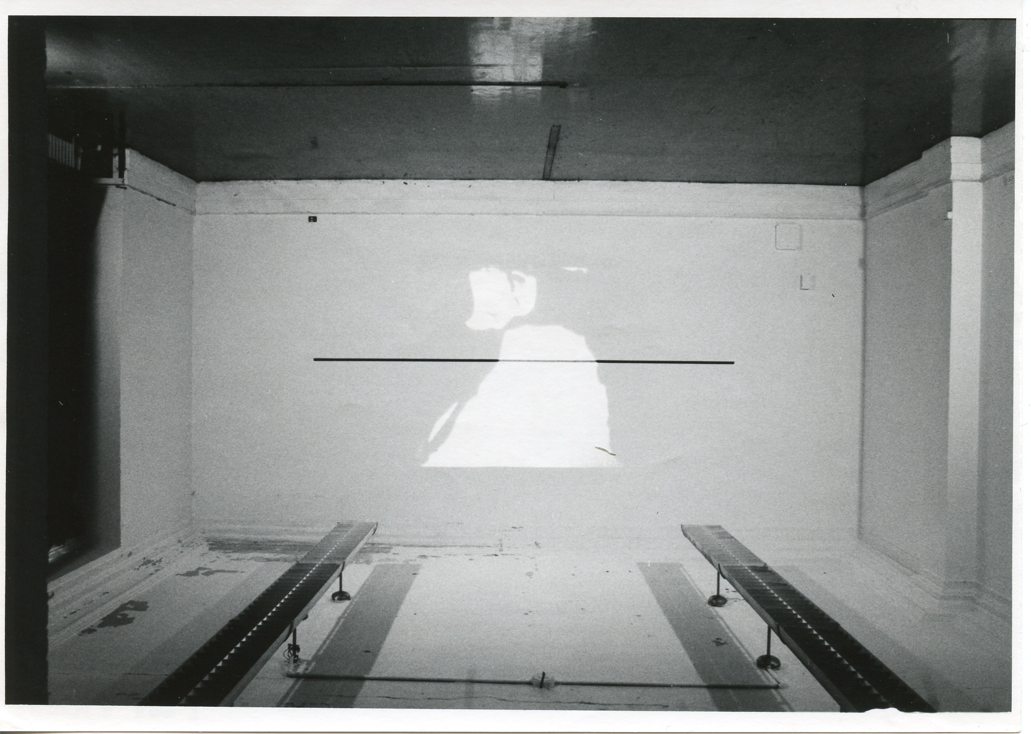 An image is projected onto a white wall.