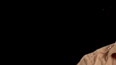 A moving image of a hand appearing in front of a black background. It's fingers positioned upwards in a wide pinch.