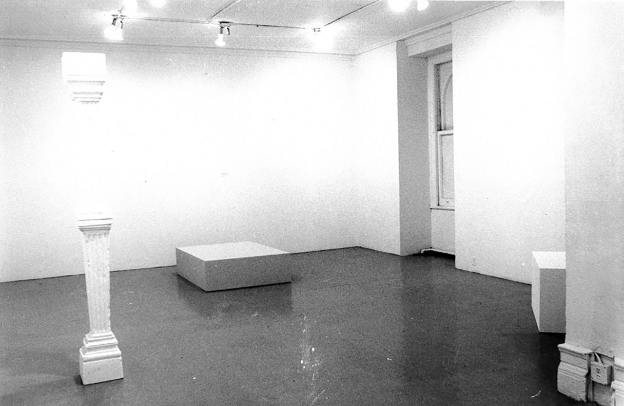 Black and white image of multiple sculptures displayed in the exhibition space.