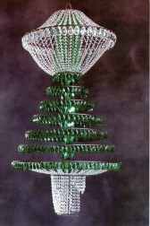A chandelier-like structure with clear crystals at its top and bottom, and green jewels arranged in increasing tiers at its center.
