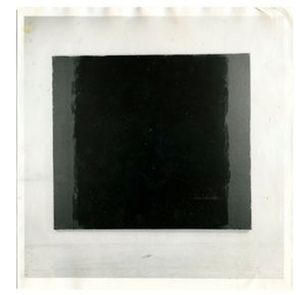 A black and white photograph of a black square painting with a lighter border on the left and right sides.