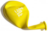 A yellow, deflated balloon, folded at the neck, with white text that reads, 
