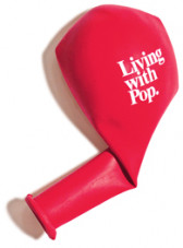 A red deflated balloon, folded at the neck, with white text that reads, 