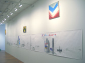 A long sheet of paper with a drawing of highway signs and a gas station on it hanging on a white wall. Hung above that are three paintings of logos.