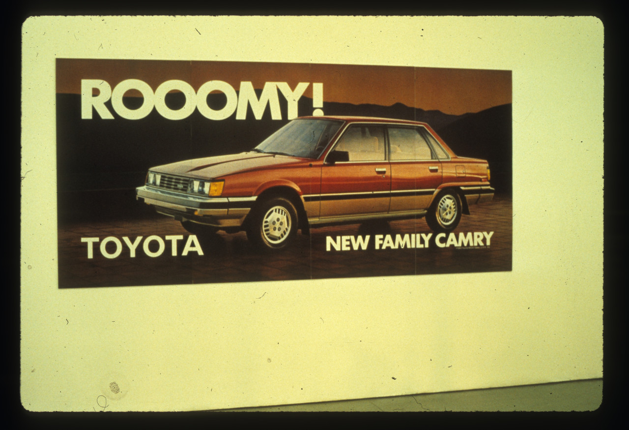 An image of a red automobile outside with the text 