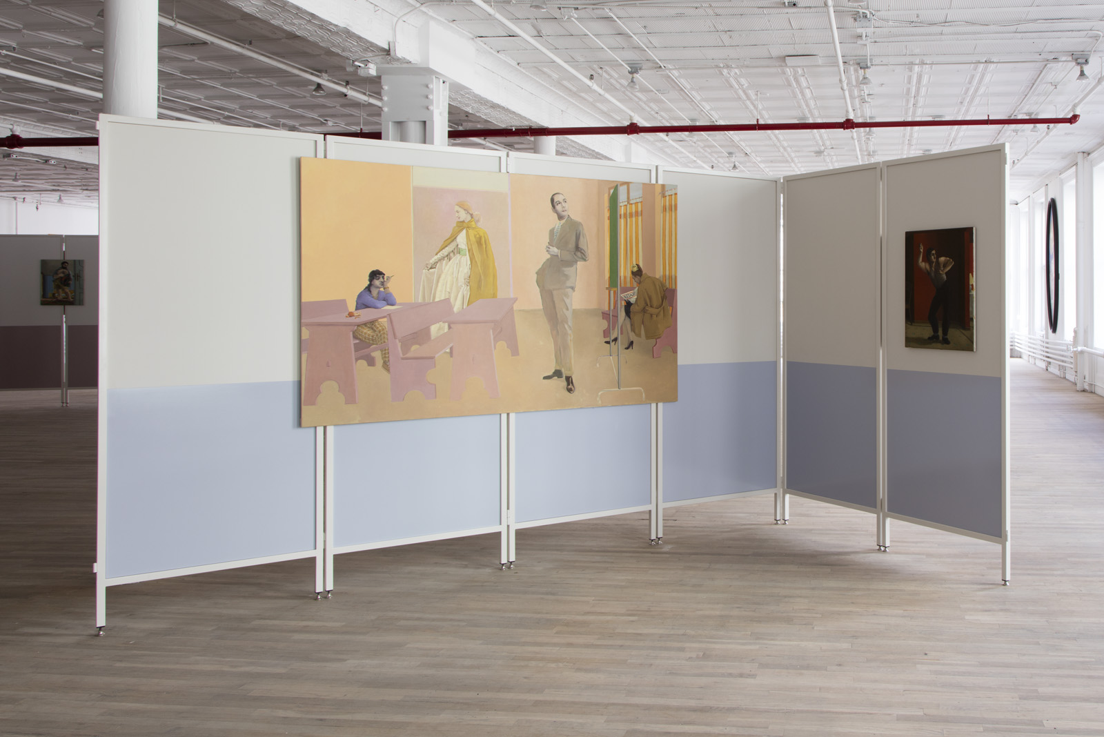Two unframed paintings are hung on a foldable room divider in a gallery. The larger painting depicts the interior of a classroom with four ambiguous figures. The smaller painting shows a man poised mid-dance.