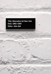 White painted brick wall; a black plate with white text that reads, 